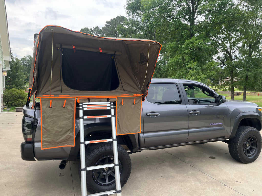 NDF-outfitting 3rd generation Toyota Tacoma truck bed rack with a tuff stuff alpha roof top tent mounted on top.